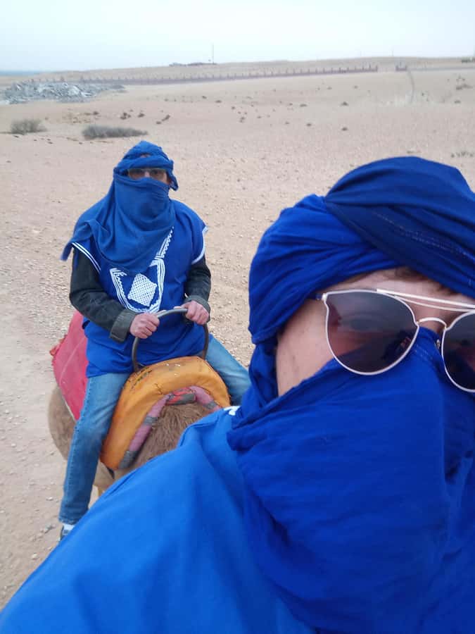 From Marrakech: Agafay Desert Sunset, Camel Ride, and Dinner - Riding a camel along the Berber path
