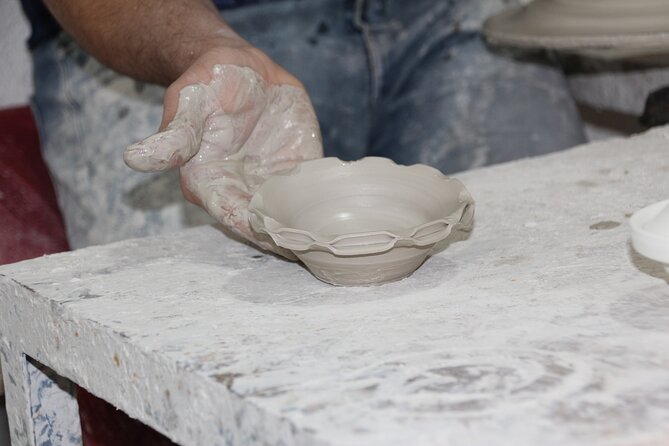 Interactive Pottery Painting and Zellige Mosaic Workshop in Fes - Shaping clay into a Moroccan pottery piece