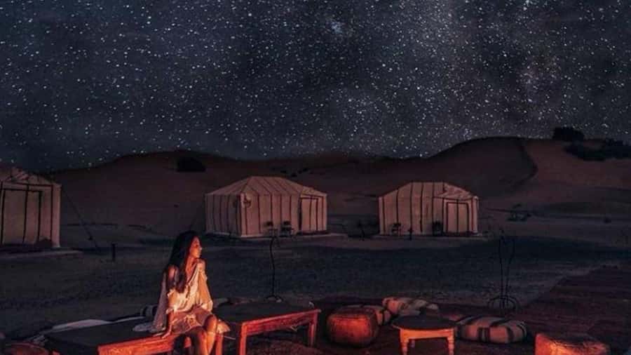 Marrakech Agafay desert: Camel Ride, Sunset, Dinner show - A desert camp lit by lanterns
