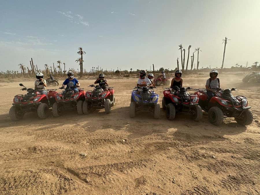 Marrakech: Desert and Palm Grove Sunset Quad Tour with Tea - Languages, cancellation, and useful booking details