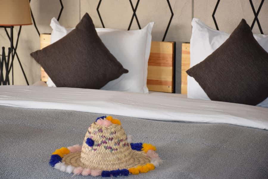 Merzouga: Overnight Stay in Luxury Desert Tent with Dinner - Riding a camel toward sunset